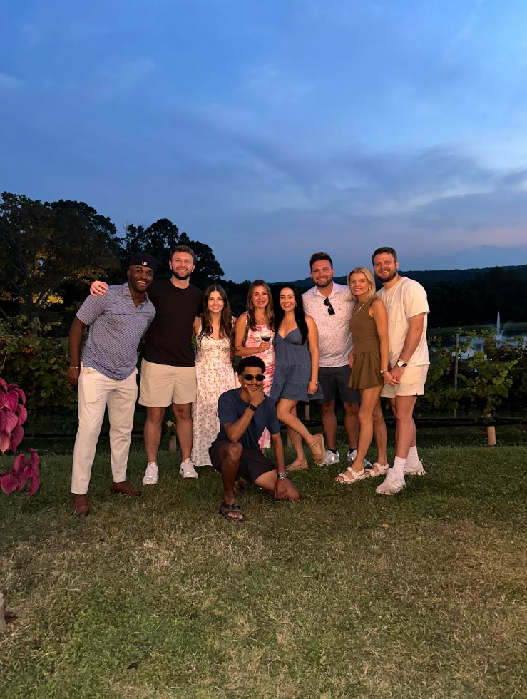 Allison and Jacob with friends at a winery at dusk
